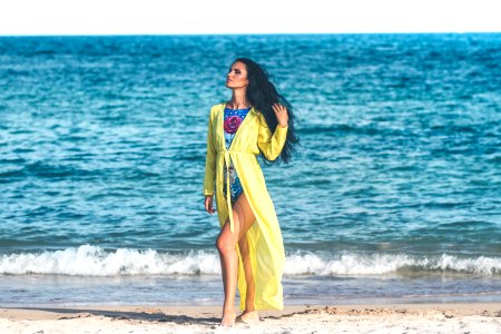 Woman Wearing Blue Monokini Standing On Beach Sand photo
