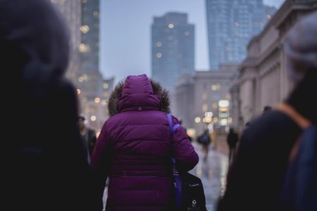 Selective Focus Photograph Of Person Wearing Purple Hoodie Jacket Walking On Street photo