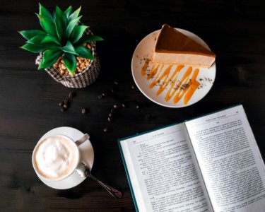 Opened Book Near Custard Cake And Coffee photo