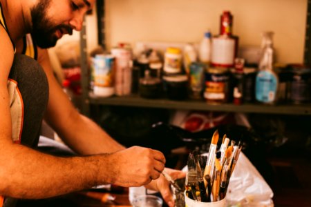 Person Holding Paint Brushes