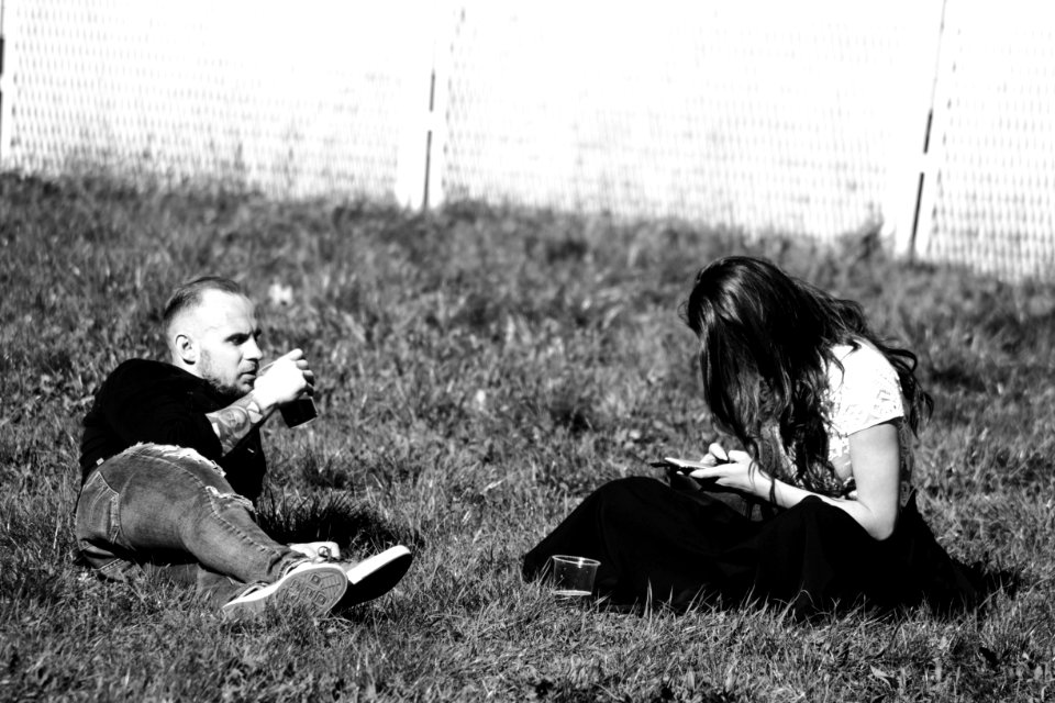 Grayscale Photography Of Man And Woman On Grass
