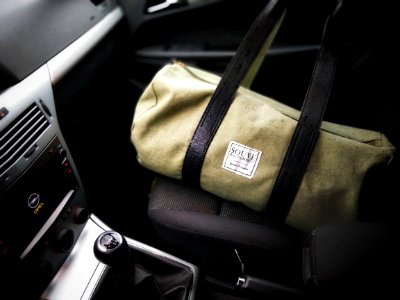 Brown And Black Duffel Bag On A Car Seat photo