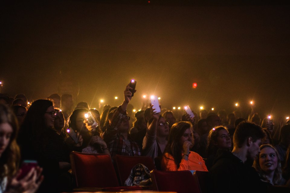 Photo Of People Holding Smartphones With Flashlight photo