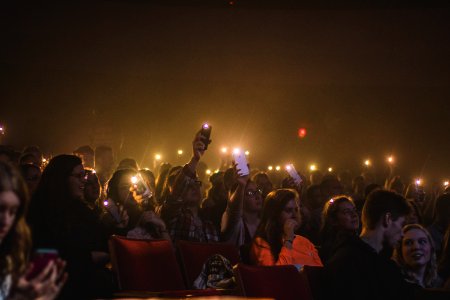 Photo Of People Holding Smartphones With Flashlight