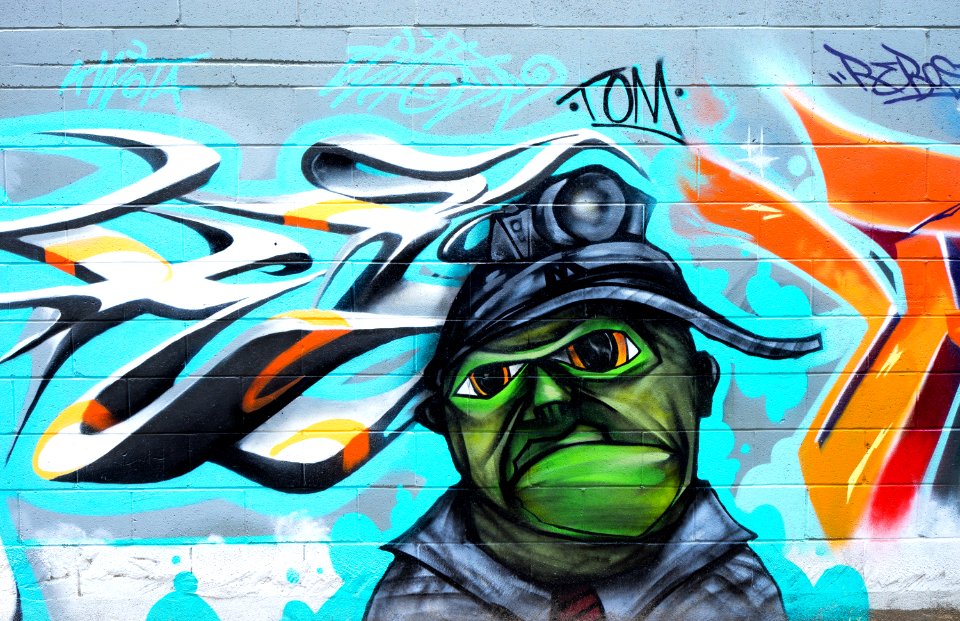 Photography Of Brick Wall With Graffiti