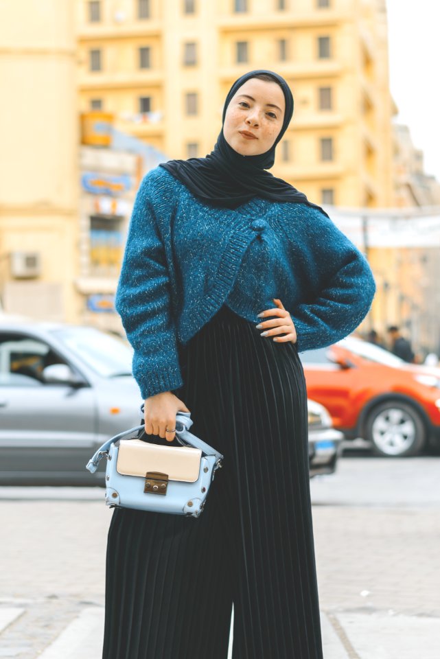 Woman Wears Blue And Black Sweater With Pants