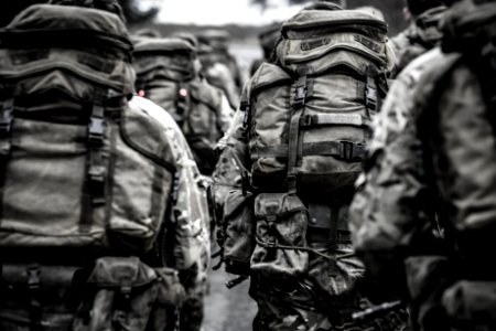 Group Of People With Camouflage Backpack