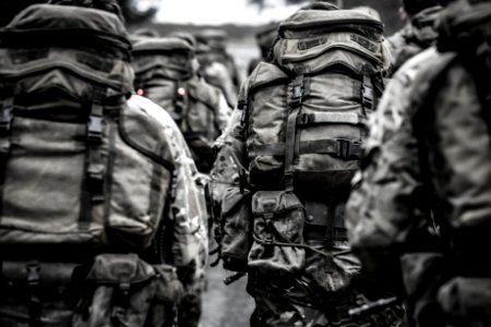 Group Of People With Camouflage Backpack photo