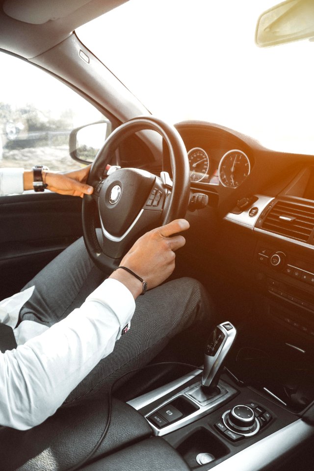 Man In White Dress Shirt Holding Steering Wheel