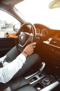 Man In White Dress Shirt Holding Steering Wheel
