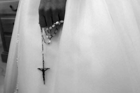 Grayscale Photo Of Person Holding Rosary photo