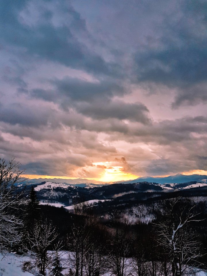 Photograph Of Snow Covered Mountains During Sunrise