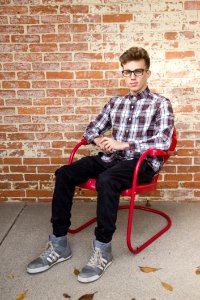 Man Wearing White And Red Long Sleeve Shirt Sitting On Red Steel Armchair photo