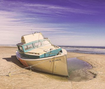 White And Teal Speedboat On Land photo