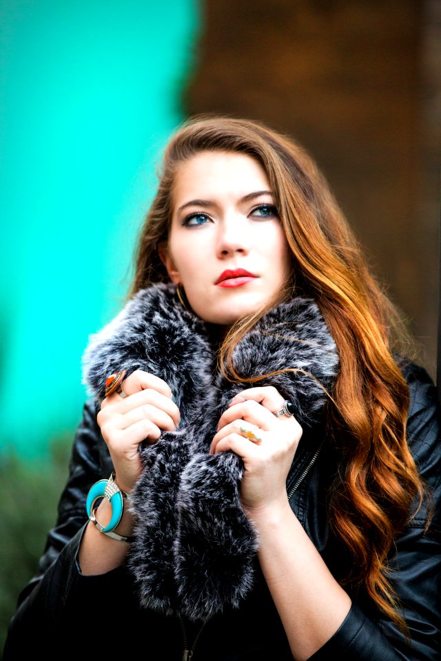 Photo Of A Woman Holding Her Black Furry Scarf