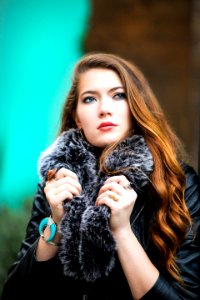 Photo Of A Woman Holding Her Black Furry Scarf photo