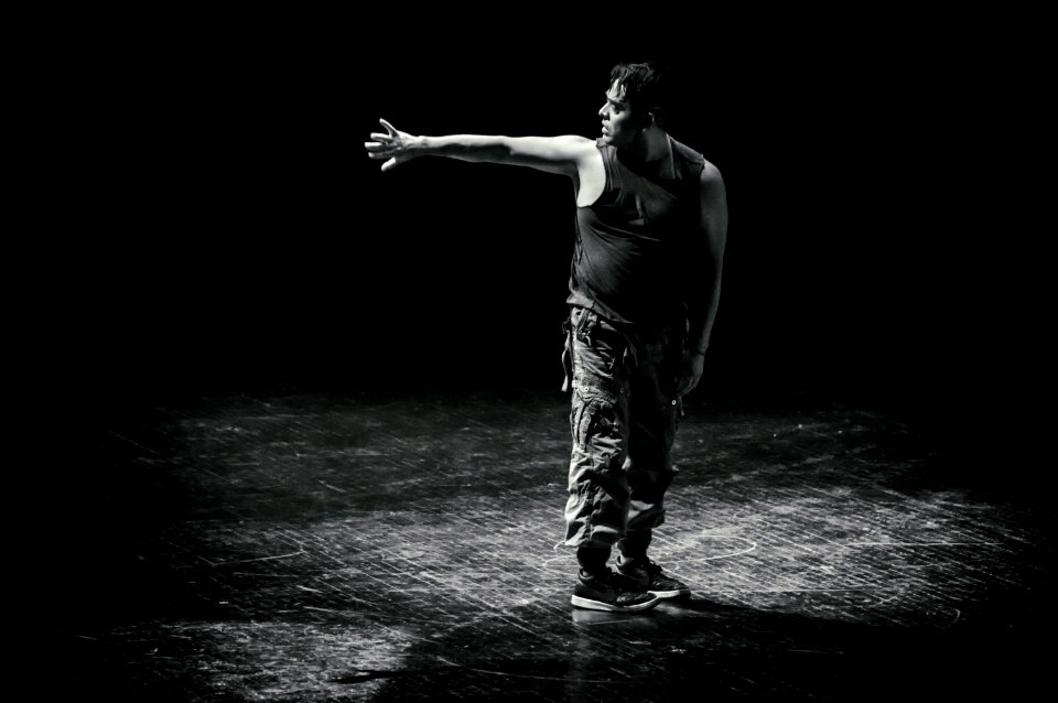 Man Standing While Raising His Hand