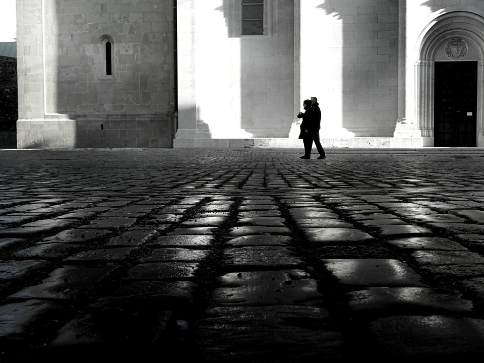 Man And Woman Walking On Empty Street