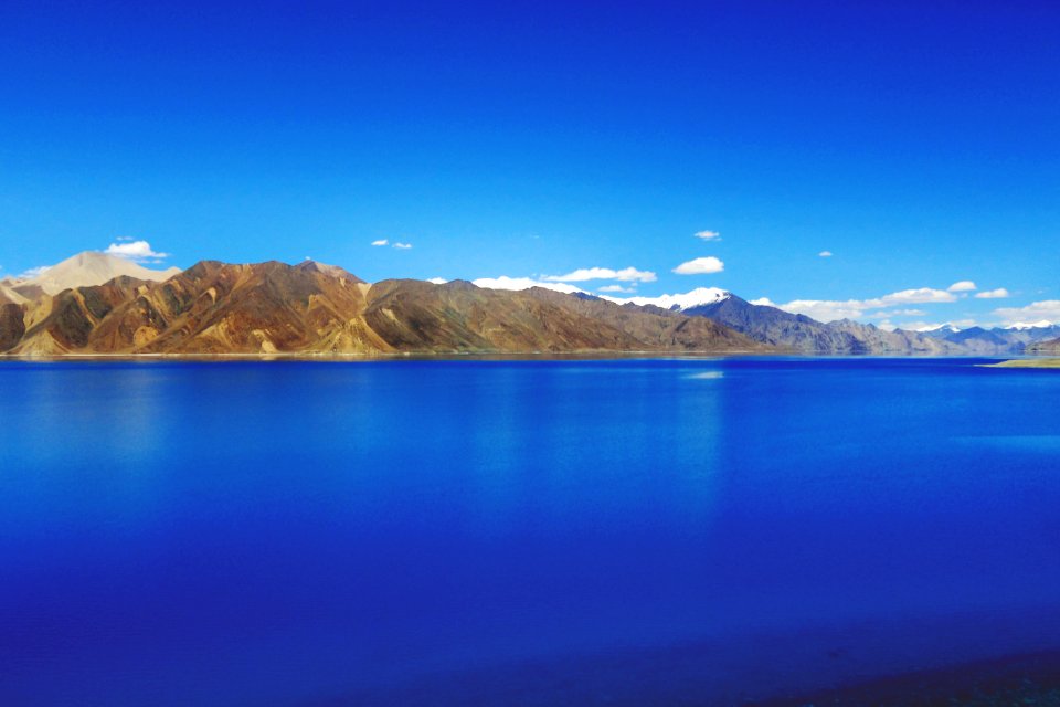 Body Of Water Near Mountain Hills