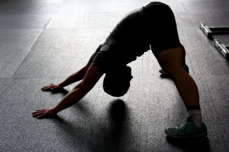 Man In Grey Shirt Doing Yoga On Gray Ceramic Tile Floor photo