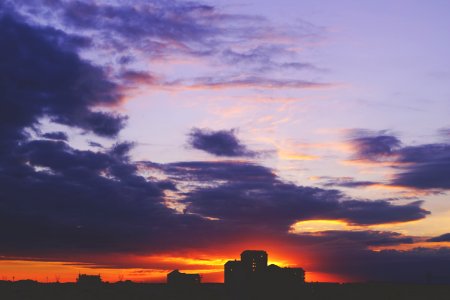 Houses Silhouetted Against Sunset