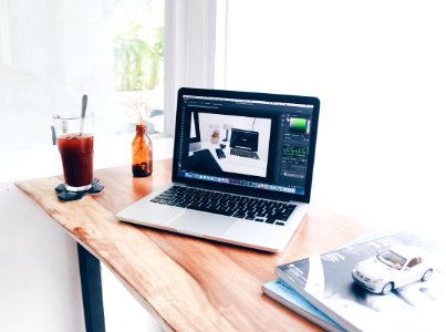 Desk With Laptop And Drink Placed On It photo