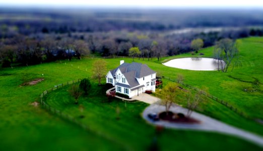 Aerial View Of House In Green Field photo
