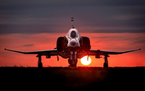 Military Jet Fighter On Runway At Sunset