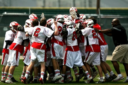 Group Of Football Player Celebrating With Coach During Daytime photo