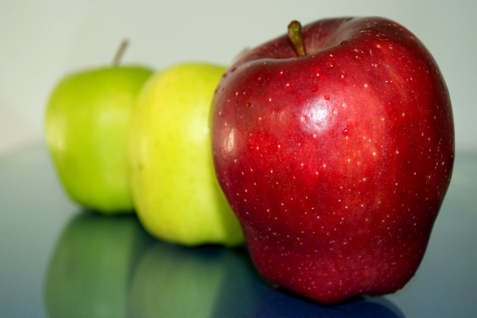 Green And Red Apples Reflection On Glass
