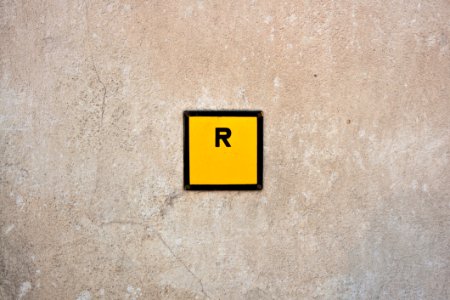 R Sign In Yellow Square