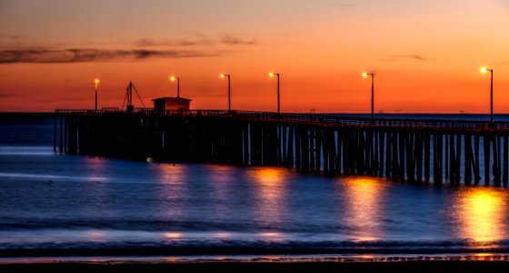 Wooden Dock On Sea Shore With Light Post During Sunset photo