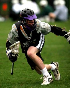 Person In Black Sports Jersey Playing Lacrosse photo