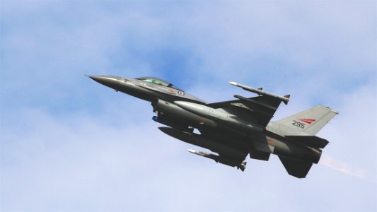 Black Jet Plane Flying Under Blue And White Sky During Daytime