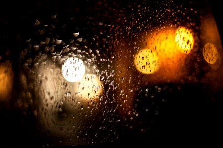 Raindrops And Light Reflecting On Window photo
