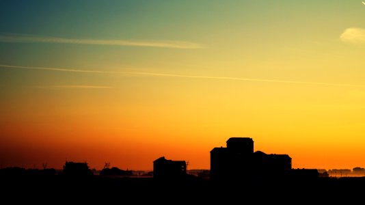 Silhouette Of High Rise Building Under Golden Sun photo