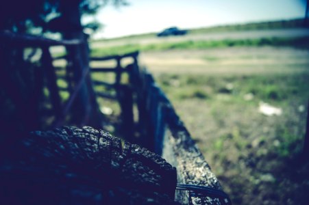 Muddy Vehicle Parked Next To Fence