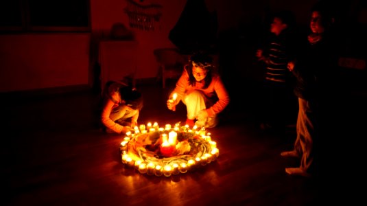 Children Lighting Candles In Circle