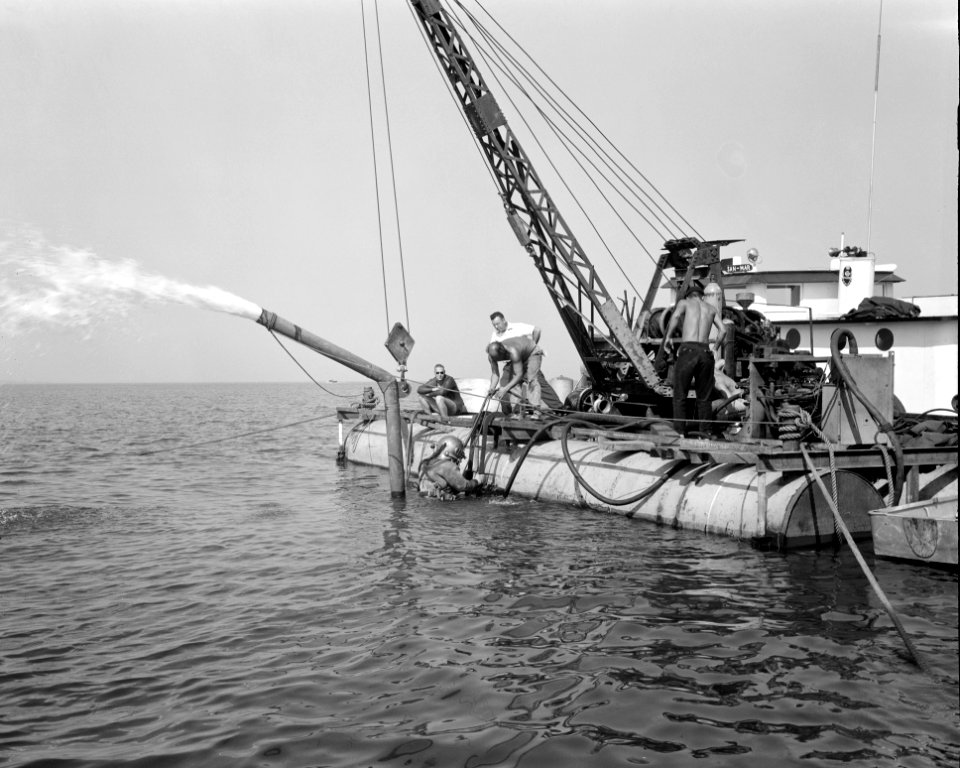 Divers Work To Clear Submerged Water Pumps