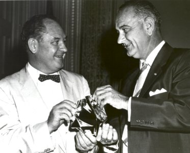 T Keith Glennan Shows LBJ Aluminized Mylar Flim Used To Make Echo I