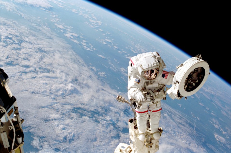 Chang-Diaz Positioned On The RMS Holding PDGF Against Earth Limb During STS-111 UF-2 EVA 1