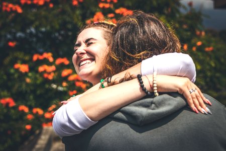Cheerful Smiling Couple In Love Hugging In Nature On A Beautiful Flower Background Bali Island