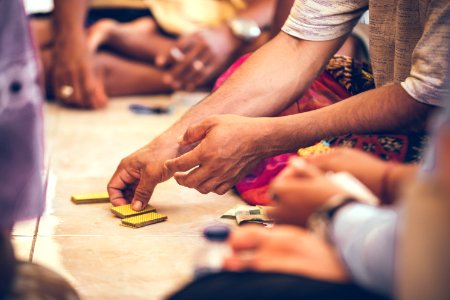 Group Of Balinese Men Playing Cards Sitting On The Floor Bali Island photo