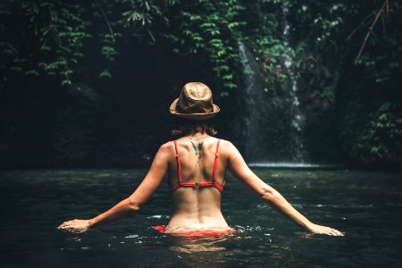 Young Woman Tourist With Straw Hat In The Deep Jungle With Waterfall Real Adventure Concept Bali Island photo