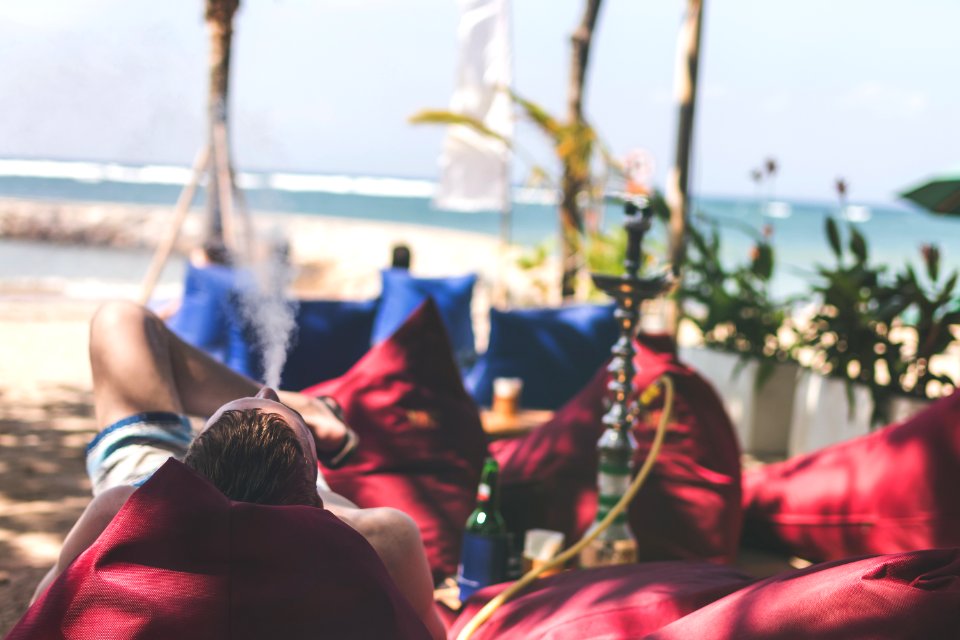 Man Smoking Hookah On A Beach Side Restaurant Next To The Sea Shisha Smoking Bali Island