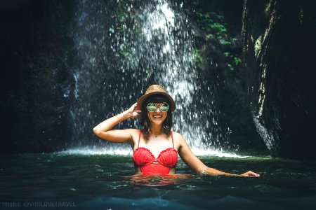 Young Woman Tourist In The Deep Jungle With Waterfall Real Adventure Concept Bali Island photo