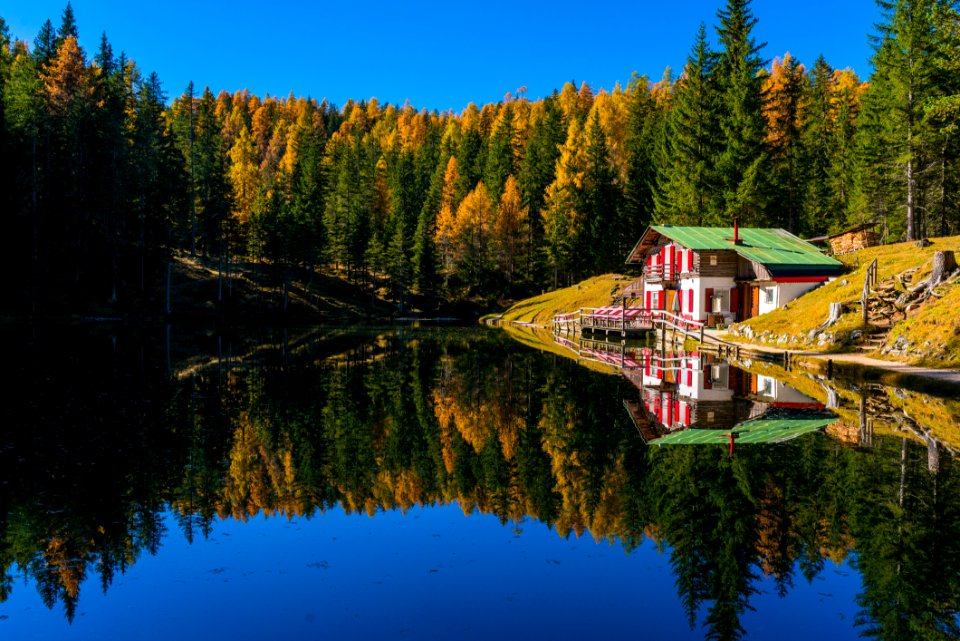 Lake House Reflecting In Calm Waters