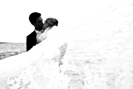 Bride And Groom Kissing On The Sea Shore photo