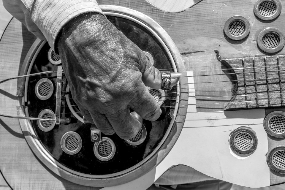 Man playing an acoustic brazilian guitar (Violo) on Marco Zero Square, Refice, Pernambuco, Brazil