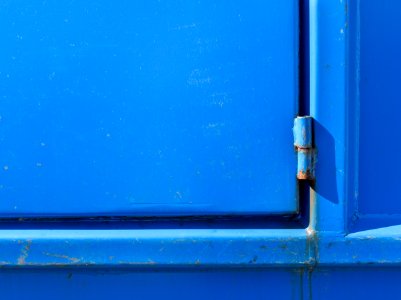 Hinge on blue dumpster